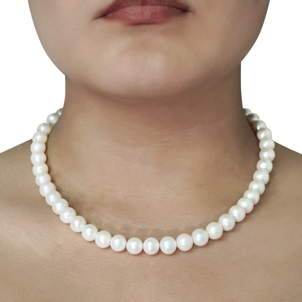 Close-up view of a white pearl necklace worn around the neck CHC Fine Jewelry